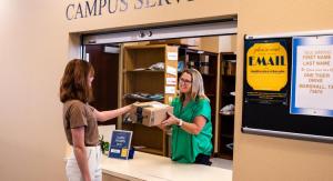 student picking up package in mail room 