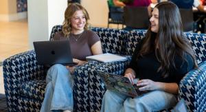 Two students working on laptops
