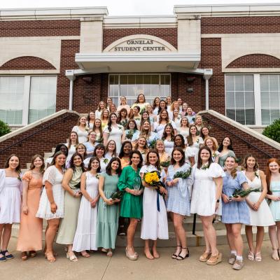 Participants in ETBU's 77th annual Senior Girl Call-Out stand on the back steps of Ornelas Student Center for a group photo